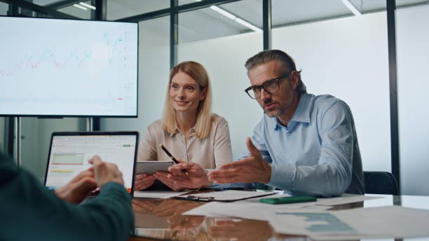 istock Confident director talking emotionally at team building. Group discussing ideas 1908033843