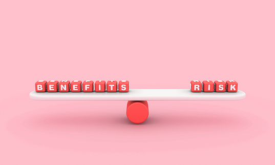 Seesaw with BENEFITS RISK Buzzword Cubes - Color Background - 3D Rendering