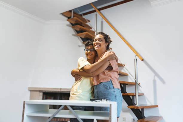 istock Mother and son hugging in their new home 1908063338
