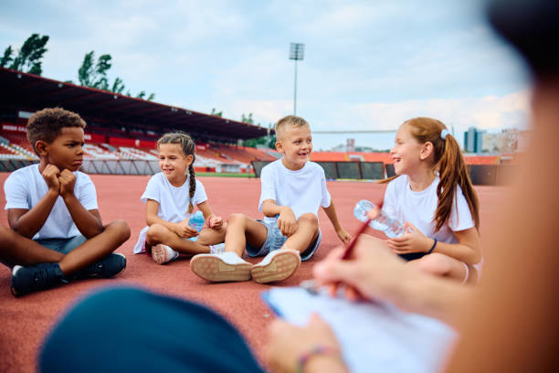 istock Happy boy and his friends during PE class at the stadium 1908078301