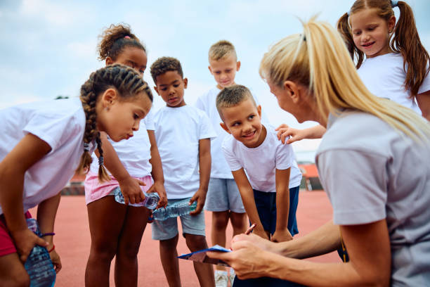 istock Group of kids and their coach going through exercise plan during sports training. 1908079276