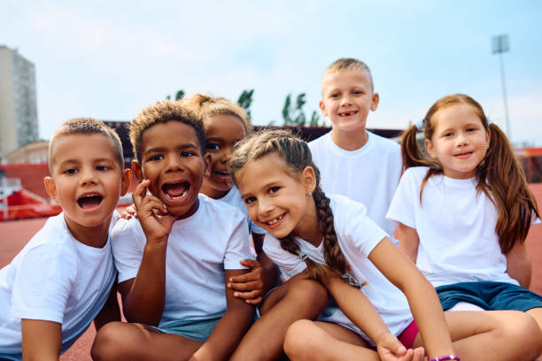 istock Multiracial group of cheerful kids during exercise class at the stadium. 1908081959