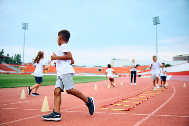istock Black kid and his friends having PE class at the stadium. 1908082996
