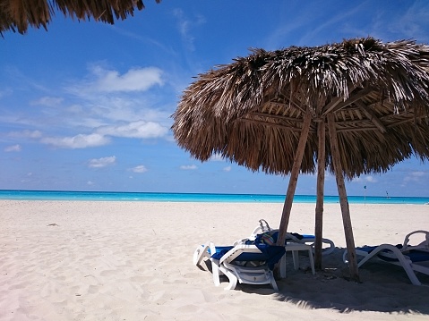 View of the sea on Varadero beach in Cuba with deck chair and sunshade