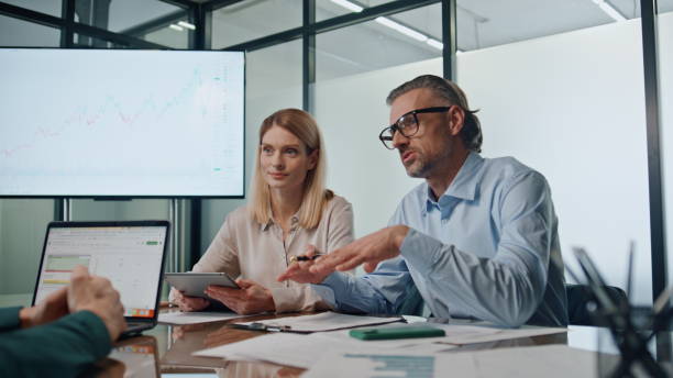 istock Inspired businessman talking meeting with business partners. Group briefing 1908106139