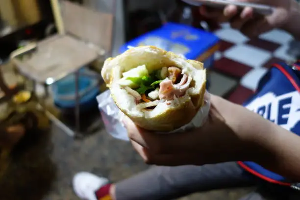 Close up of a half eaten Vietnamese bánh mì in Ho Chi Minh City, Vietnam