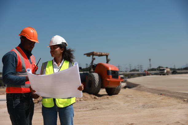 istock Civil engineer and technician with safety vest working on road construction site 1908142147