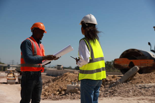 istock Civil engineer and technician with safety vest working on road construction site 1908142650