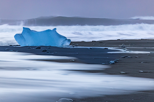 dramatic iceberg on the black sand of Diamond Beach, Iceland