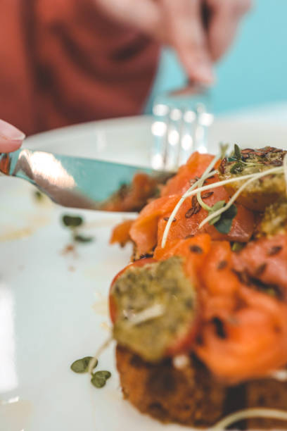 istock Girl in a cafe eating avocado toast 1908158536
