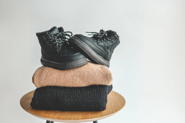 istock Stack of sweaters and boots, style and fashion 1908169311