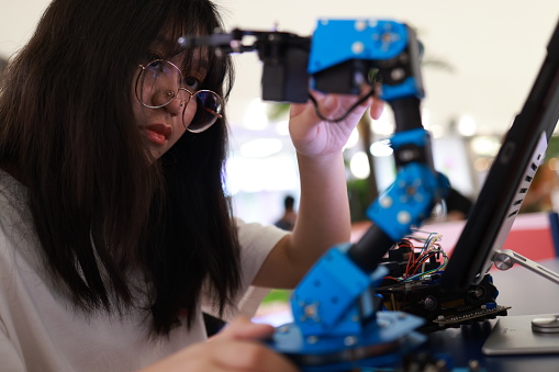 Girl doing and learning  robot KIT