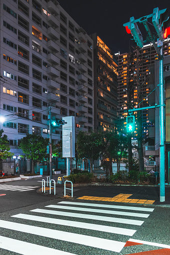 Empty street and city lights at midnight in Tokyo
