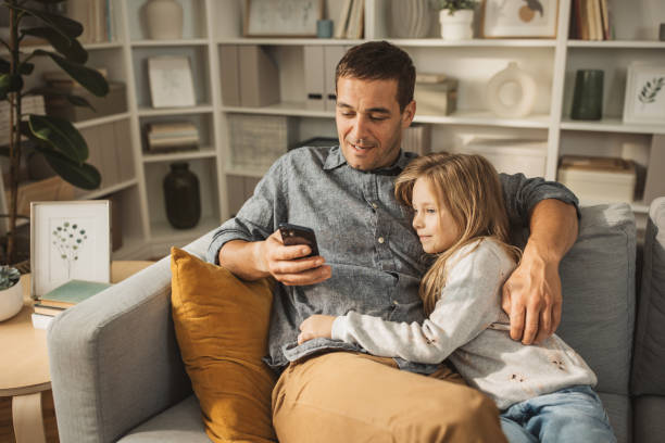 istock Close up smiling loving young father hugging adorable little daughter 1908199057