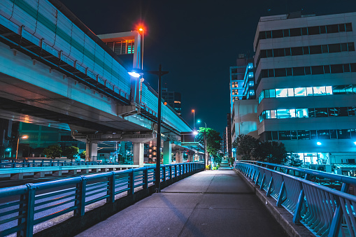 Highway bridge and city lights at midnight in Tokyo