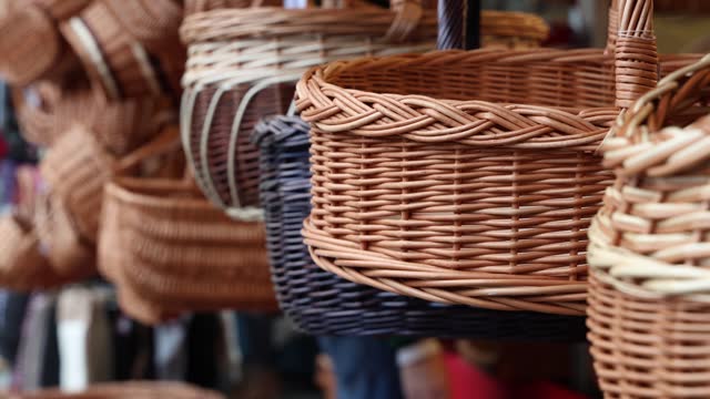 Woven baskets for sale, handmade crafts establishing shot