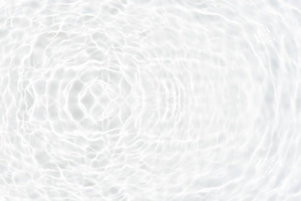 istock White water with ripples on the surface. Defocus blurred transparent white colored clear calm water surface texture with splashes and bubbles. Water waves with shining pattern texture background. 1908302818