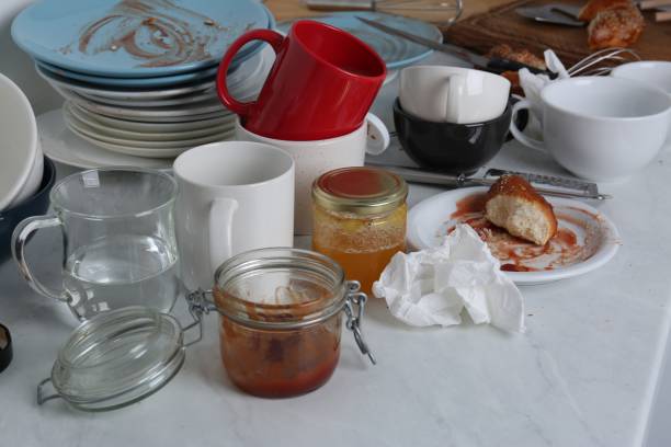 istock Many dirty utensils, dishware and food leftovers on countertop in messy kitchen 1908307533