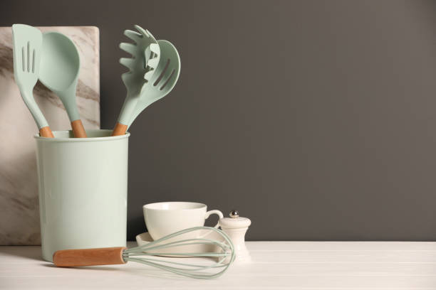 istock Set of different kitchen utensils on white wooden table against grey background, space for text 1908307546