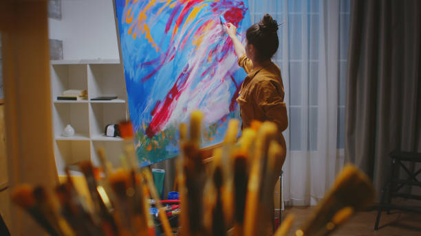istock Artist choosing the right paint brush 1908307646