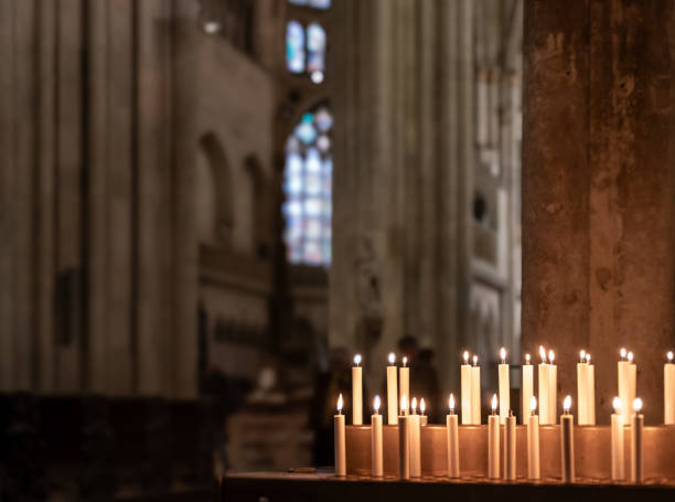 istock blurred interior of catholic church with  burning candle; abstract background 1908322620