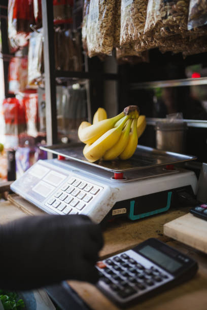 istock Fruit vendor weighing bananas on scale. Small business in Chile. 1908323151