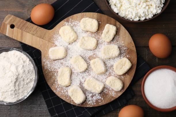 istock Making lazy dumplings. Board with cut dough and ingredients on wooden table, flat lay 1908329039