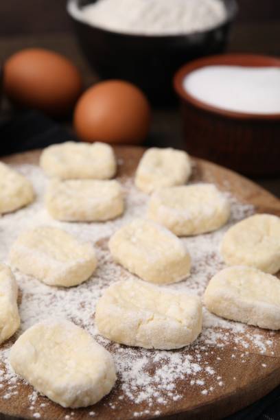istock Making lazy dumplings. Wooden board with cut dough and ingredients on table, closeup 1908329057