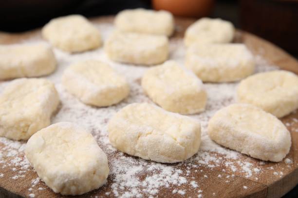 istock Making lazy dumplings. Cut dough and flour on wooden board, closeup 1908329427