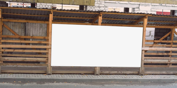 istock Empty white banner with mockup mounted on wooden scaffolds on urban street 1908333525