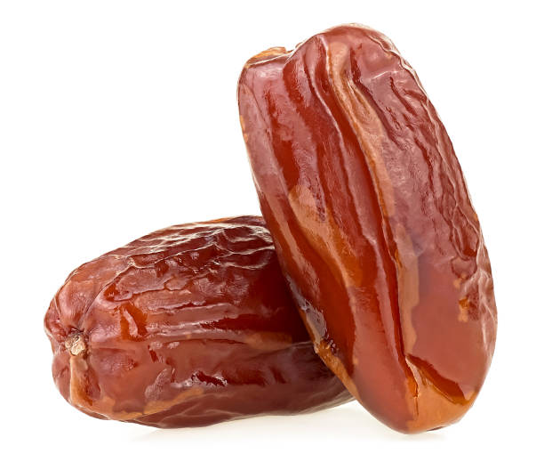 istock Two tasty dried dates isolated on a white background. Dried date palm fruits. 1908335206