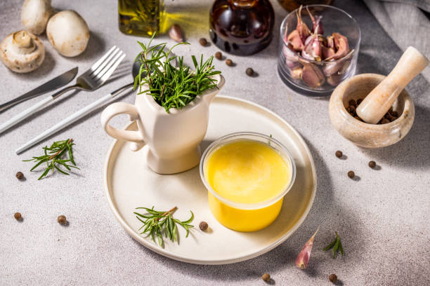 istock Melted butter in jar surrounded by ingredients for cooking and herbs 1908336916