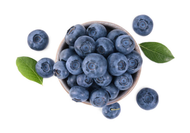 istock Fresh ripe blueberries and leaves isolated on white, top view 1908351671