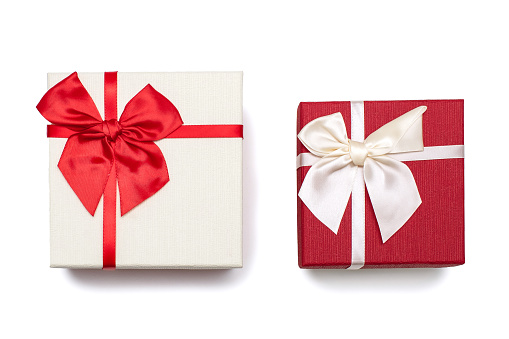 Two white and red gift boxes with ribbons and bows on a white background. Gifts for birthday or traditional holidays. Two gift boxes close up