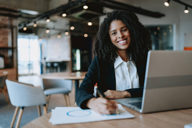 istock Young businesswoman using laptop at desk 1908371813