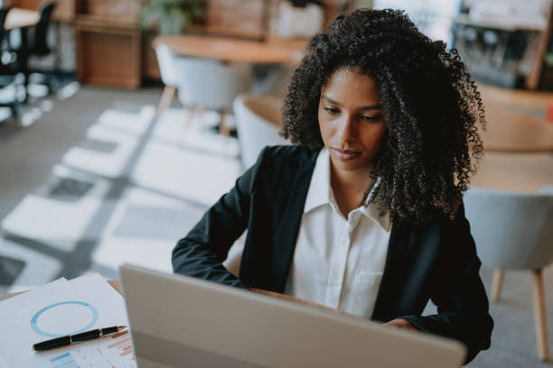 istock Young businesswoman using laptop at desk 1908372050