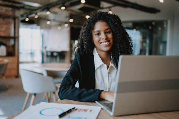 istock Young businesswoman using laptop at desk 1908372240