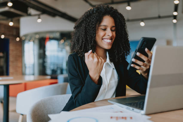 istock Young woman excitedly celebrating using laptop 1908373665
