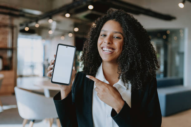 istock Young business woman showing cell phone 1908375220