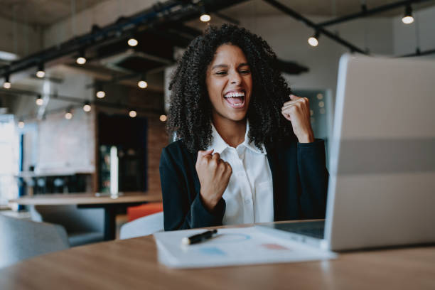 Young business woman cheering happily