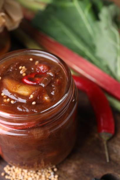 istock Tasty rhubarb sauce and ingredients on table, closeup 1908399495