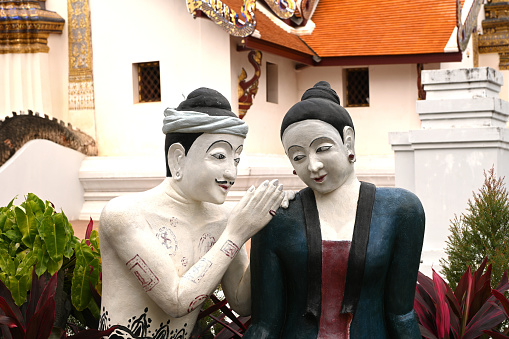 Nan Province ,Thailand- December 22 20123: The  statue of a man whispering to love his lover 
 at Wat Phumin, Nan province, Thailand.