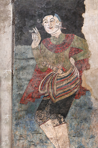 Nan Province, Thailand- December 22 20123: Mural paintings of a man from the ancient period at Phumin Temple, a famous temple in Nan Province, Thailand.