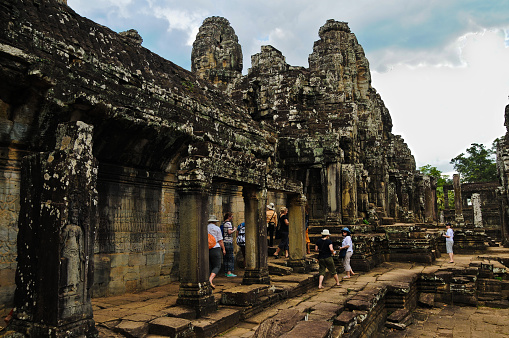 Exploring the remains of the Khmer empire on the grounds of the Angkor Wat with its many wonders and the ultimate expression of Khmer genius. The temples are intricately carved with motifs, myths and legends. Nothing compares to this, one of the world's architectural wonders. Photographed in May 2014.