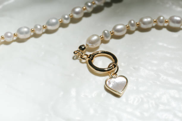 istock Elegant pearl necklace on white textured background, closeup 1908454368