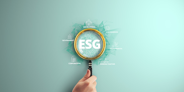 ESG: Environmental, Social, and Governance Principles at the Heart of Sustainable Corporate Development. Cultivating Eco-Awareness, Fostering Collaboration. Magnifier focus to Digital marketing icon.