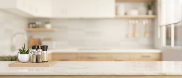 istock Spice bottles and copy space on a luxury white marble tabletop in a modern bright and clean kitchen. 1908479645
