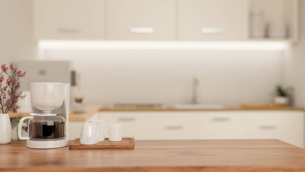 istock A copy space on a wooden kitchen tabletop with an espresso machine in a modern white kitchen. 1908481722