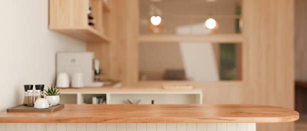 istock Copy space on a wooden kitchen countertop in a minimalist Scandinavian kitchen. 1908482264