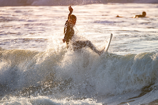 Surfer in action at sunset. Furadouro beach, Ovar - Portugal.